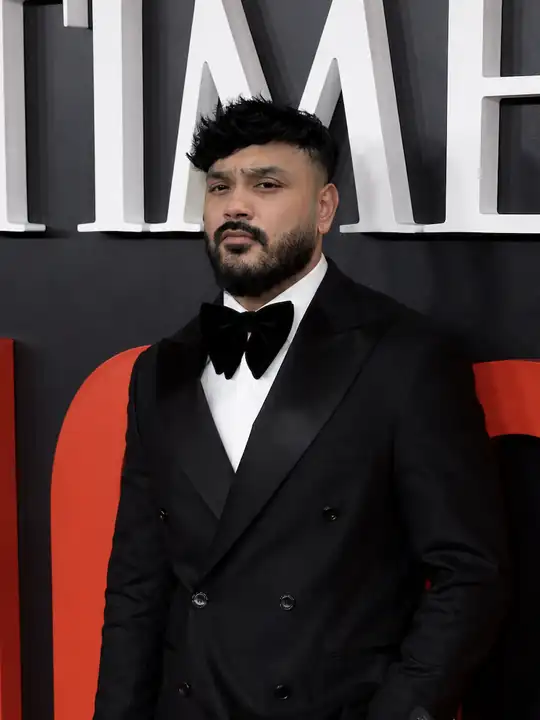 Zayd in black tie at an industry event